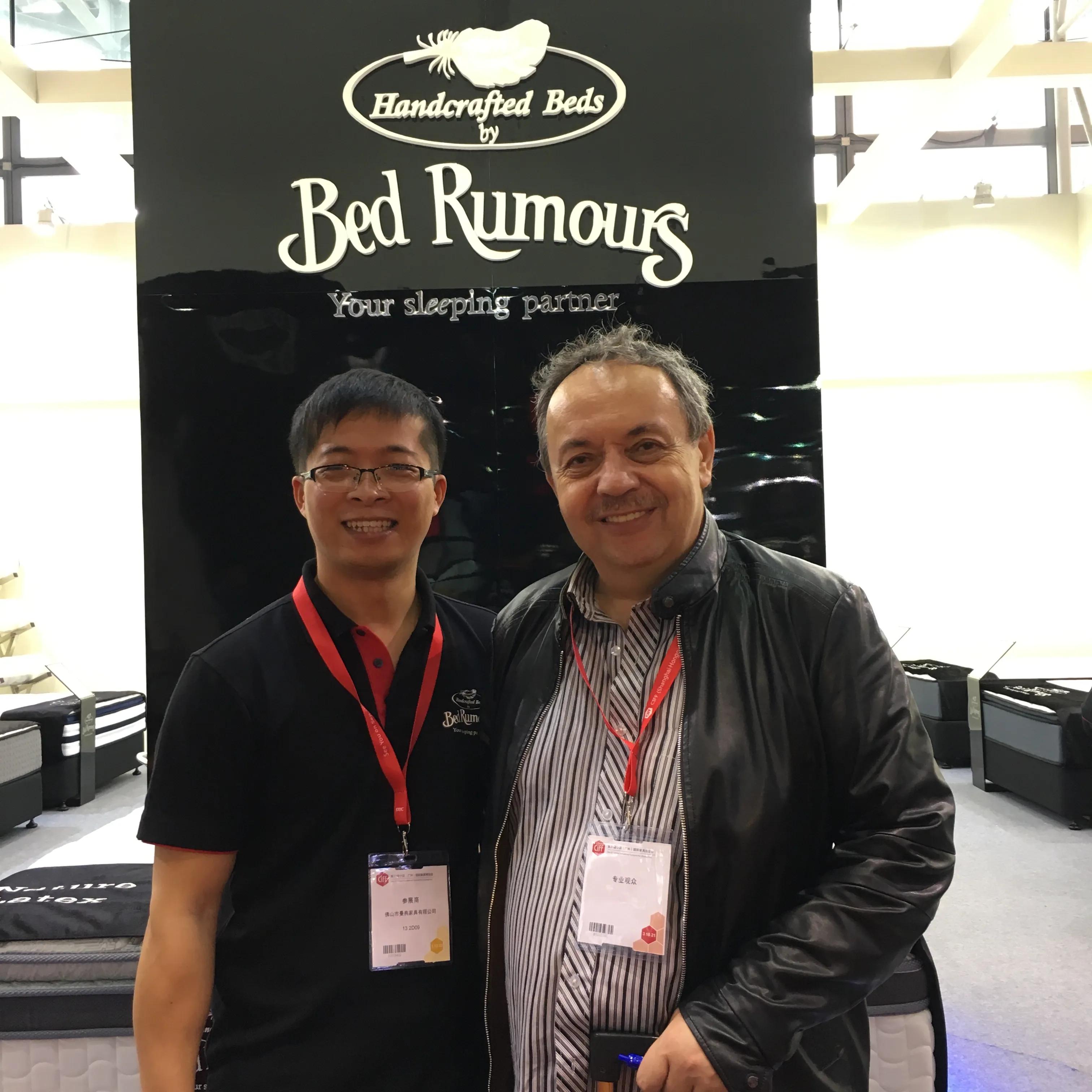 Customer reviewing mattress products with Bed Rumours team